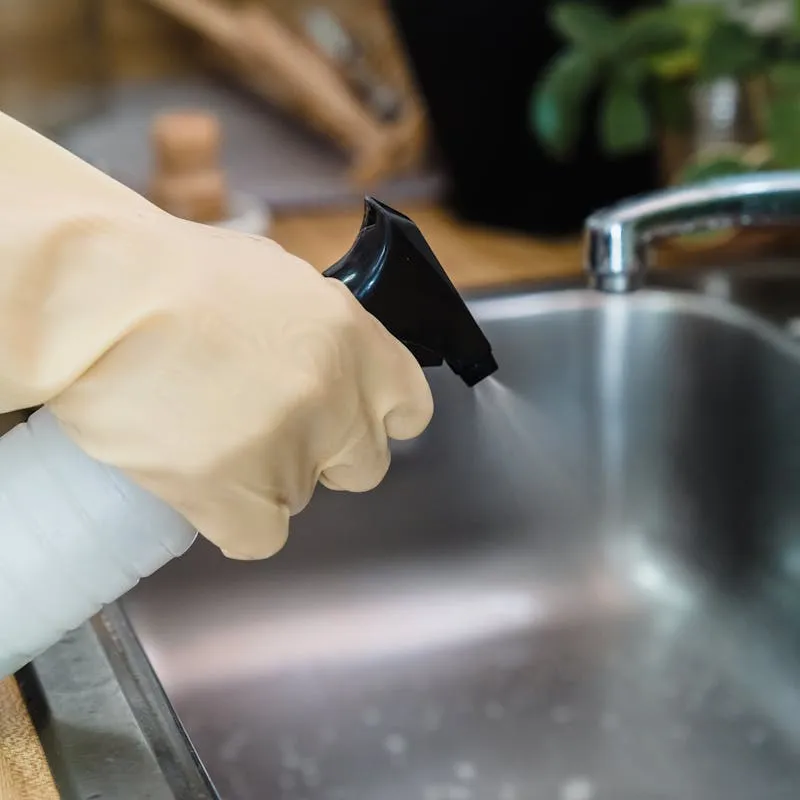 Plumber cleaning a kitchen sink drain